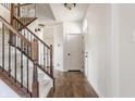 Bright foyer featuring hardwood floors, staircase with wooden rails, and natural light at 664 Hythe Way, Westfield, IN 46074