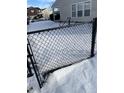 Backyard with wrought iron fence during winter, home in background at 6886 W Raleigh Dr, McCordsville, IN 46055