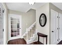 Inviting foyer showcases hardwood floors, staircase and entry to other rooms in the home at 7929 Castle Lake Rd, Indianapolis, IN 46256