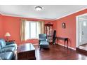 Cozy living room is painted in a peach color and features hardwood floors and a window at 7929 Castle Lake Rd, Indianapolis, IN 46256