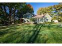 Two-story home on a large lot, featuring mature trees and lush green lawn at 8090 E 550 S, Zionsville, IN 46077