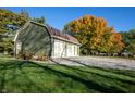 Exterior view of a detached two-car garage on a spacious lot, with fall foliage at 8090 E 550 S, Zionsville, IN 46077