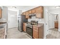 Functional kitchen featuring stainless steel appliances, wood cabinets, and easy access to the home's entrance at 827 N Tacoma Ave, Indianapolis, IN 46201
