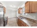 Open concept kitchen offering wood cabinets, updated stainless steel appliances, and view of the living area at 827 N Tacoma Ave, Indianapolis, IN 46201