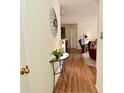 Hallway features wood flooring and decorative mirror, leading to a cozy living space at 8830 Yardley Ct # 103, Indianapolis, IN 46268