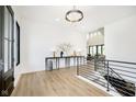 Bright foyer features hardwood floors, modern light fixture, and a decorative console table at 907 Oak Terrace Rd, Westfield, IN 46074