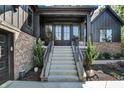 The front entrance boasts a stairway with black metal railings and a well-manicured landscape at 907 Oak Terrace Rd, Westfield, IN 46074
