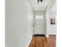 Inviting entryway with hardwood floors and white front door at 910 N Downey Ave, Indianapolis, IN 46219