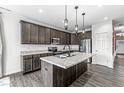 Modern kitchen with granite countertops, stainless steel appliances, and a center island at 9442 Orchard Cove Dr, Indianapolis, IN 46239