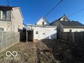 Wide backyard between two houses with a detached garage at 959 E Georgia St, Indianapolis, IN 46202