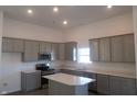 Modern kitchen with gray cabinetry, stainless steel appliances, quartz countertops, and a center island at 10126 Camp Creek Way, Indianapolis, IN 46229
