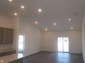 Bright and airy living room boasts recessed lighting, a sliding glass door, and modern, neutral finishes at 10126 Camp Creek Way, Indianapolis, IN 46229