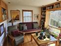 Inviting living room featuring a window view, built-in bookshelves and seating at 10821 E County Road 750 N, Brownsburg, IN 46112