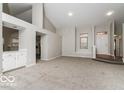 Open living room featuring a high ceiling, neutral colors, and new carpeting at 10891 Santa Anita Ct, Carmel, IN 46280
