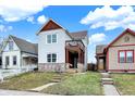 Charming two-story home with stone accents and a small balcony overlooking the front yard at 1111 Fletcher Ave, Indianapolis, IN 46203