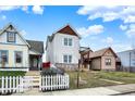 Charming two-story home with stone accents and a small balcony overlooking the front yard at 1111 Fletcher Ave, Indianapolis, IN 46203