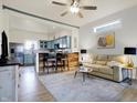 Bright, open living room and kitchen featuring hardwood floors, stylish decor, and a modern breakfast bar at 1111 Fletcher Ave, Indianapolis, IN 46203