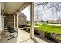 Relaxing front porch with seating area overlooking the landscaped front yard at 11686 Belle Plaine Blvd, Fishers, IN 46037