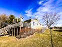 A spacious wooden deck overlooking a backyard, enhanced by lush greenery and a classic wooden fence at 12930 River Grove Dr, Columbus, IN 47203