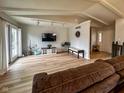 Bright living room featuring a TV, wood floors, bench and glass patio doors at 12930 River Grove Dr, Columbus, IN 47203