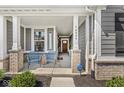 Inviting front porch with seating area, perfect for relaxing and enjoying the neighborhood views at 14234 Community Dr, Carmel, IN 46033