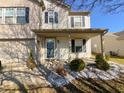 Covered front porch featuring decorative columns and landscaped garden with small shrubs and stones at 14243 Holly Berry Cir, Fishers, IN 46038