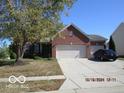 Beautiful brick home with a spacious driveway and a well-manicured front lawn at 1429 Lavender Ln, Greenwood, IN 46143