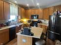 Well-equipped kitchen featuring stainless steel appliances, island, and wooden cabinetry at 1429 Lavender Ln, Greenwood, IN 46143
