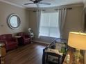 Inviting living area with red accent chairs, wood flooring, and a ceiling fan at 1429 Lavender Ln, Greenwood, IN 46143