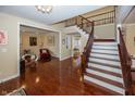 Spacious living room with hardwood floors, staircase, and neutral walls at 14375 Alderbrook Trl, Carmel, IN 46033