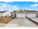 Charming home featuring attached two car garage, neutral siding, and manicured lawn at 1615 Clover Crossing Dr # 2A, Greenfield, IN 46140