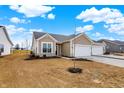 Charming home featuring attached two car garage, neutral siding, and space for landscaping at 1615 Clover Crossing Dr # 2A, Greenfield, IN 46140