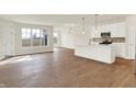 Open-concept living room with abundant natural light and beautiful hardwood floors at 1615 Clover Crossing Dr # 2A, Greenfield, IN 46140