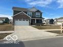 Inviting two-story home featuring a two-car garage and a freshly paved driveway at 1670 Crossley St, Fortville, IN 46040