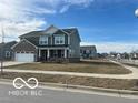 Charming two-story home with a well-manicured lawn in a friendly neighborhood setting at 1670 Crossley St, Fortville, IN 46040