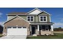 Beautiful two-story home with a modern exterior, featuring a two-car garage, stylish brick, and siding accents at 1670 Crossley St, Fortville, IN 46040