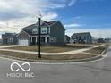 Charming two-story home with a well-manicured lawn and a sidewalk in a friendly neighborhood at 1670 Crossley St, Fortville, IN 46040