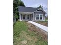 Cozy home exterior with a new concrete walkway and front yard at 1974 Ralston Ave, Indianapolis, IN 46218