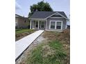 Charming home with a new concrete walkway and freshly landscaped front yard at 1974 Ralston Ave, Indianapolis, IN 46218