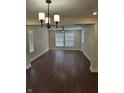 Spacious living room featuring hardwood floors, modern light fixtures, and bright natural light at 1974 Ralston Ave, Indianapolis, IN 46218