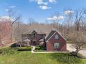 Spacious brick home on a large lot with mature trees and a well-maintained lawn at 2163 Laurel Leaf Ln, Avon, IN 46123