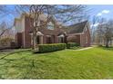 Two-story brick home with well-kept lawn, garden, and a manicured, verdant front yard at 2163 Laurel Leaf Ln, Avon, IN 46123