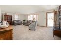Spacious living room with neutral carpet, comfortable sofas, natural light, and a welcoming atmosphere at 229 W Taylor St, Pendleton, IN 46064