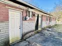 The backyard features a door and window with brick exterior, and concrete at 260 W 33Rd St, Indianapolis, IN 46208