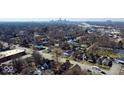 An aerial view capturing the neighborhood with charming homes, mature trees, and distant city skyline at 2839 E 19Th St, Indianapolis, IN 46218