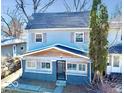 Charming two-story home featuring light blue siding, wood accents, and well-maintained landscaping at 2839 E 19Th St, Indianapolis, IN 46218