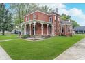 Traditional brick home with a welcoming front porch, offering curb appeal and outdoor space at 300 S Market St, Thorntown, IN 46071
