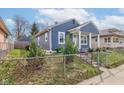 Charming blue home with white trim and covered porch exudes curb appeal and a welcoming entrance at 301 Villa Ave, Indianapolis, IN 46201