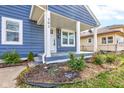 Charming blue home with white trim and covered porch exudes curb appeal and a welcoming entrance at 301 Villa Ave, Indianapolis, IN 46201