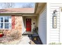 Inviting front entrance featuring a red door, brick accents, and clear house number display at 4238 Vestry Ct, Indianapolis, IN 46237